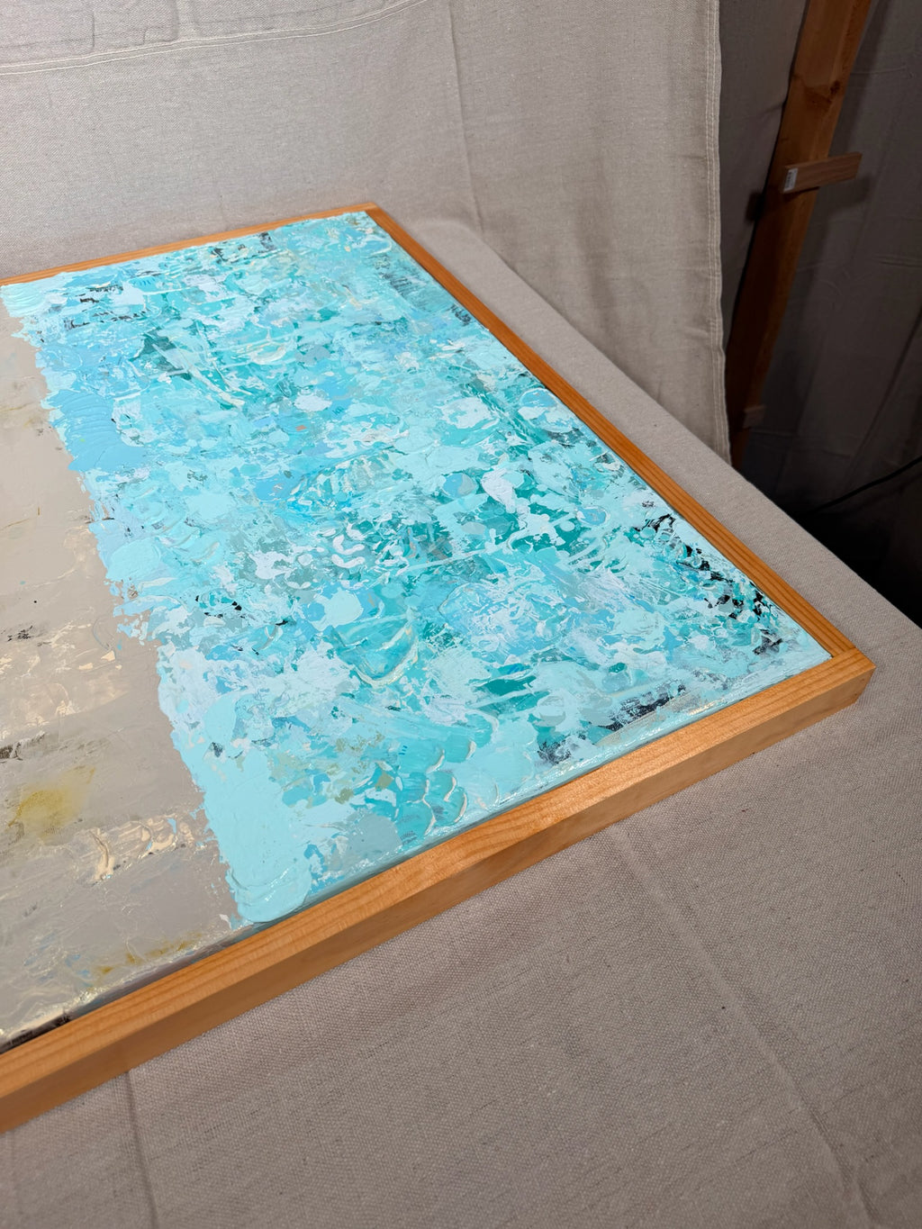 Angled close-up of The Money Keeps Us Divided showing the speckled turquoise lower half with flecks of gold and white.