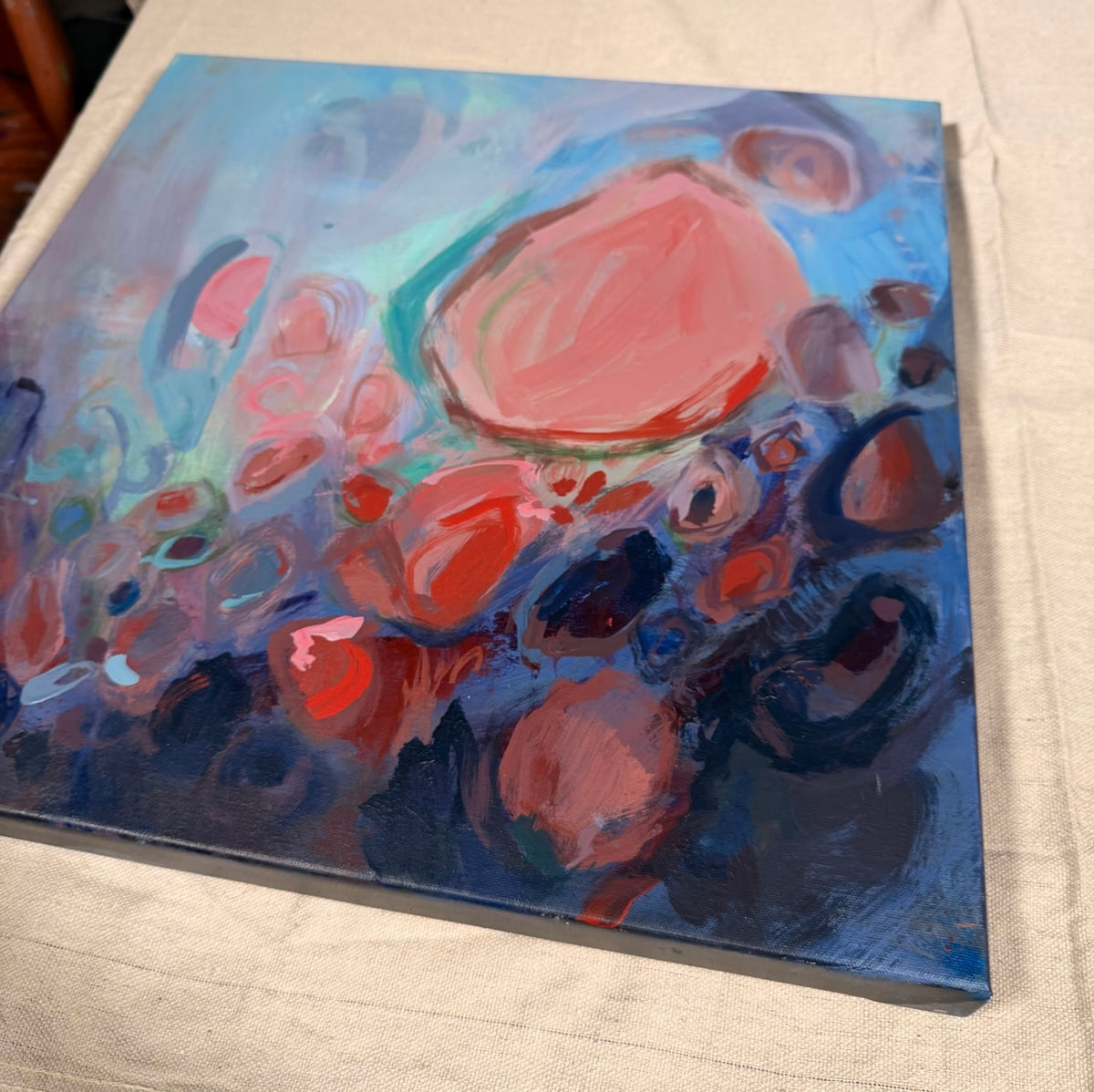 Soul Nourished, I Bloom Anew, a square abstract: a large coral bloom rises above clusters of rose, red and navy circles on a misty blue background.