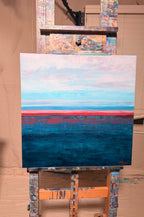 Rest in Your Peace on a studio easel: soft pink and pale blue sky, a thin coral horizon line, and a deep, textured teal sea below.