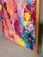 Angled close-up of Thought Trains, Like High Voltage Electricity Running Through My Veins showing thick, raised dabs of coral, magenta, yellow and navy paint beside the wood frame.