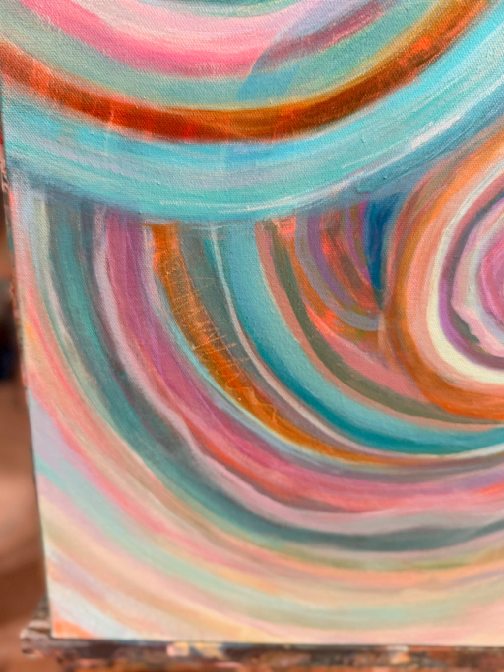 Close-up of Abundance where curving bands of copper, turquoise and rose meet and overlap.