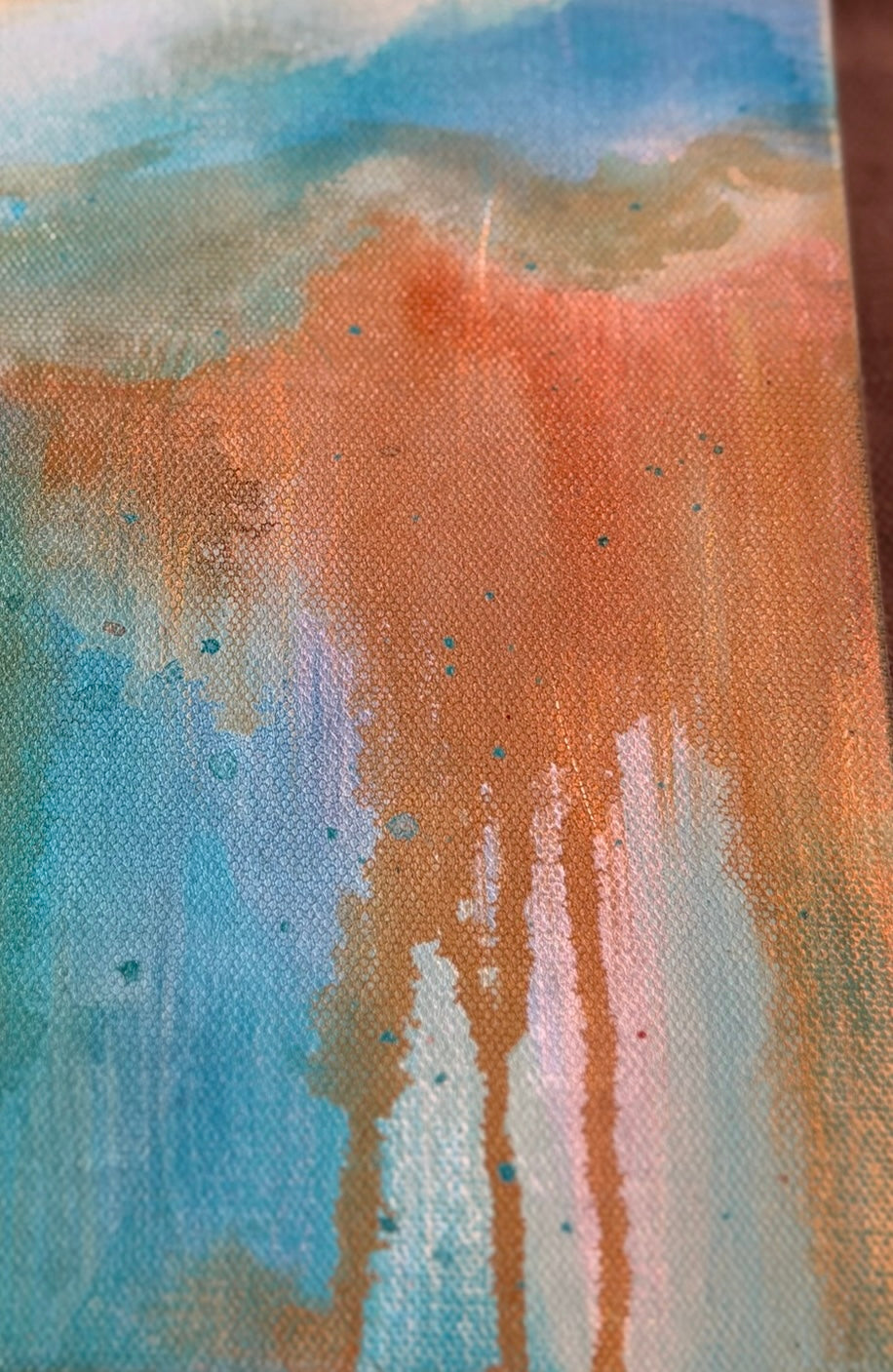 Close-up of As The Path Unfolds showing rusty orange paint dripping down through layers of sky blue and cream on textured canvas.