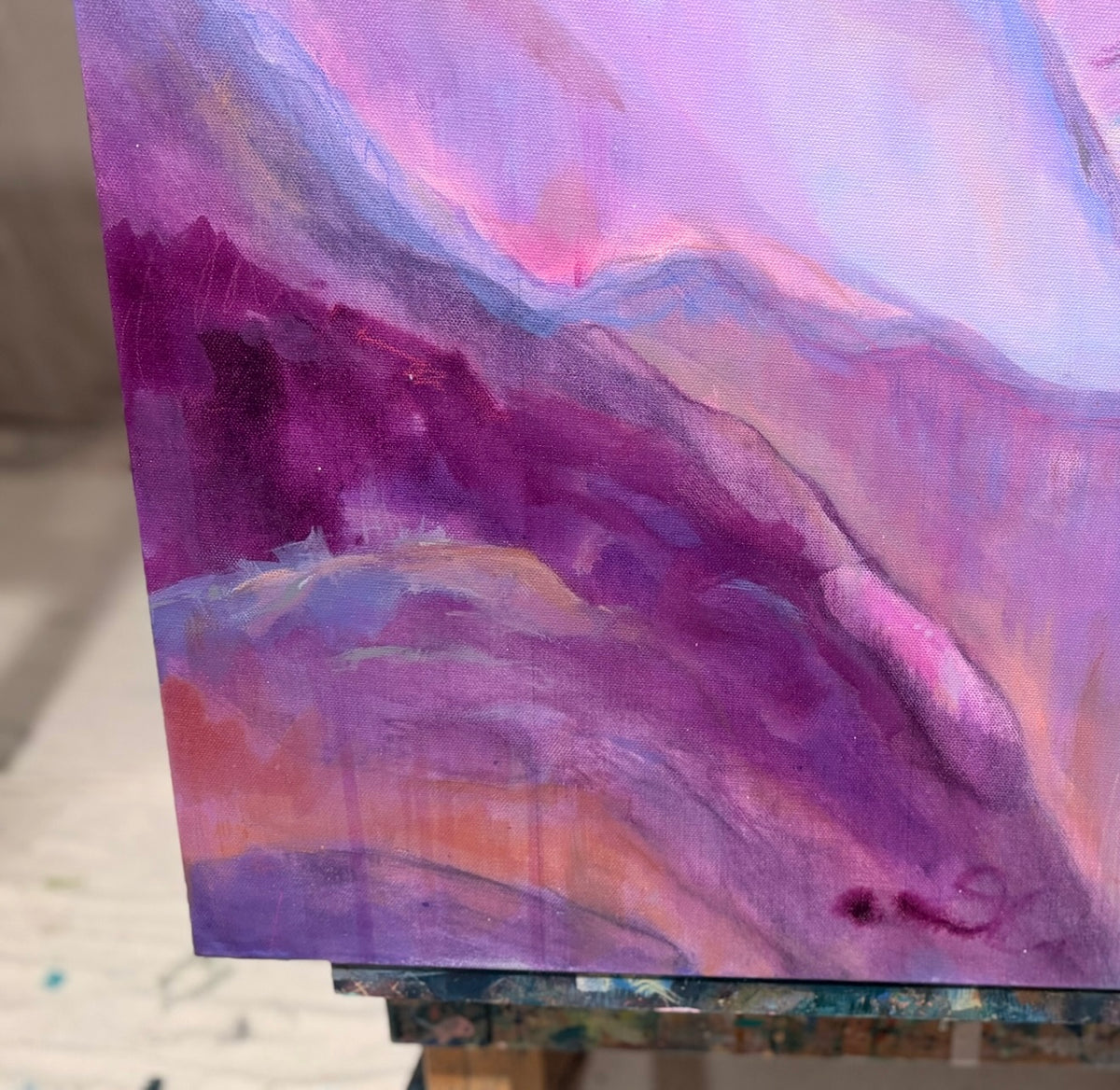 Close-up of The View From My Latest Summit: soft lavender and pink ridges fold over deep plum valleys, with Kindra's signature at the lower edge.