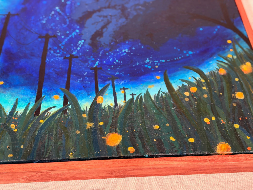 Close-up of The View From The Grass showing speckled deep blue sky, silhouetted poles and textured green grass sprinkled with orange firefly glows.