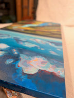 Angled close-up of the top of Where the Cahaba Winds, showing soft white and pink clouds on a deep blue sky and the painted canvas edge.