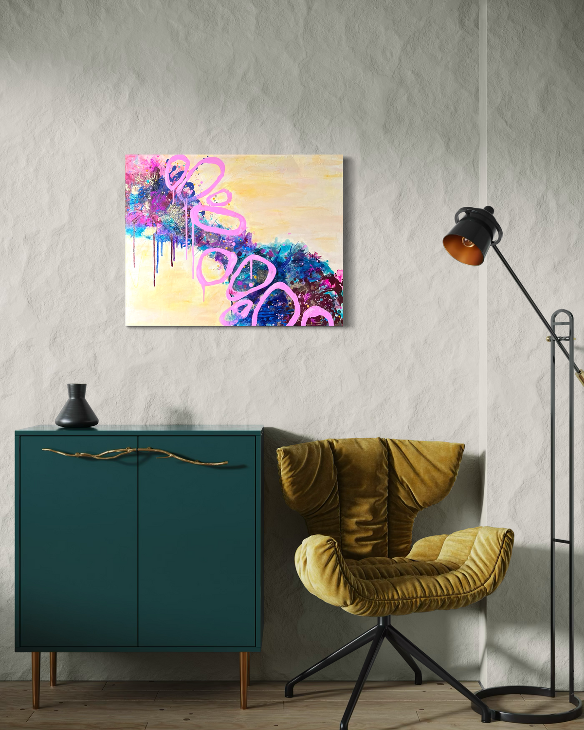 Beautiful Mess, an abstract in mixed media on stretched canvas: an hourglass of magenta, violet and blue wrapped in bold pink loops on soft yellow, shown above a teal cabinet.