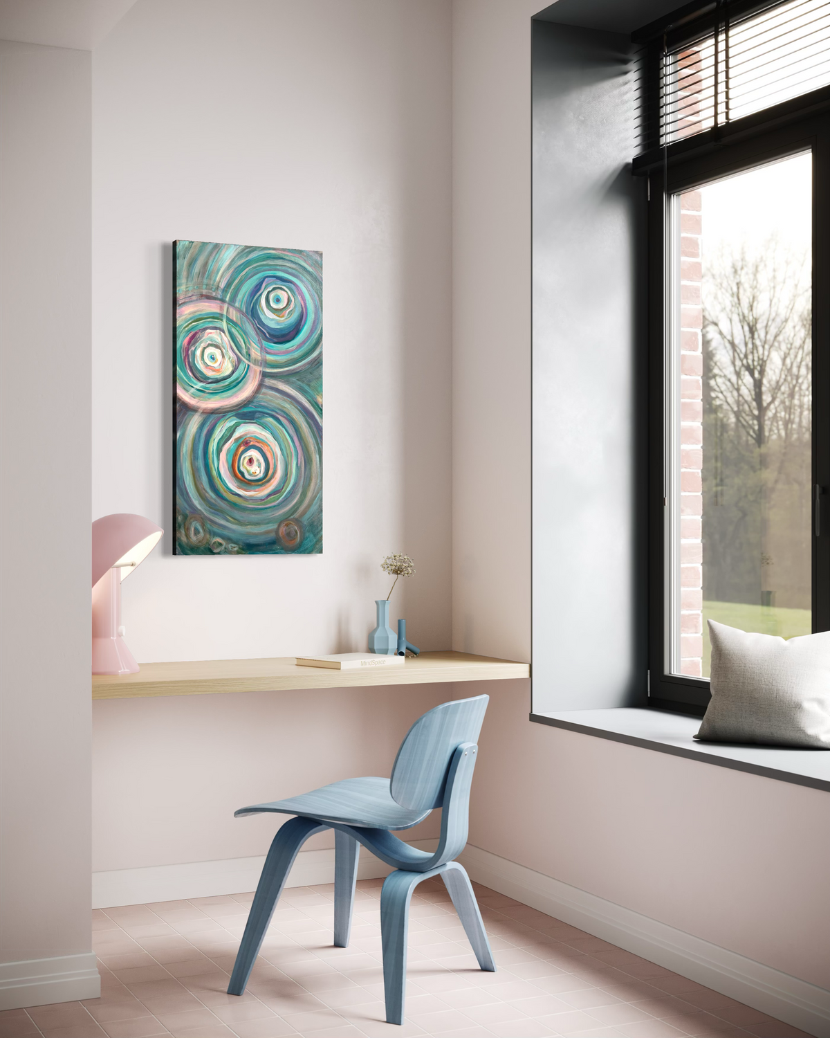 Presence hanging above a floating desk in a soft pink study by a window, its concentric teal and cream ripples rising up the canvas.