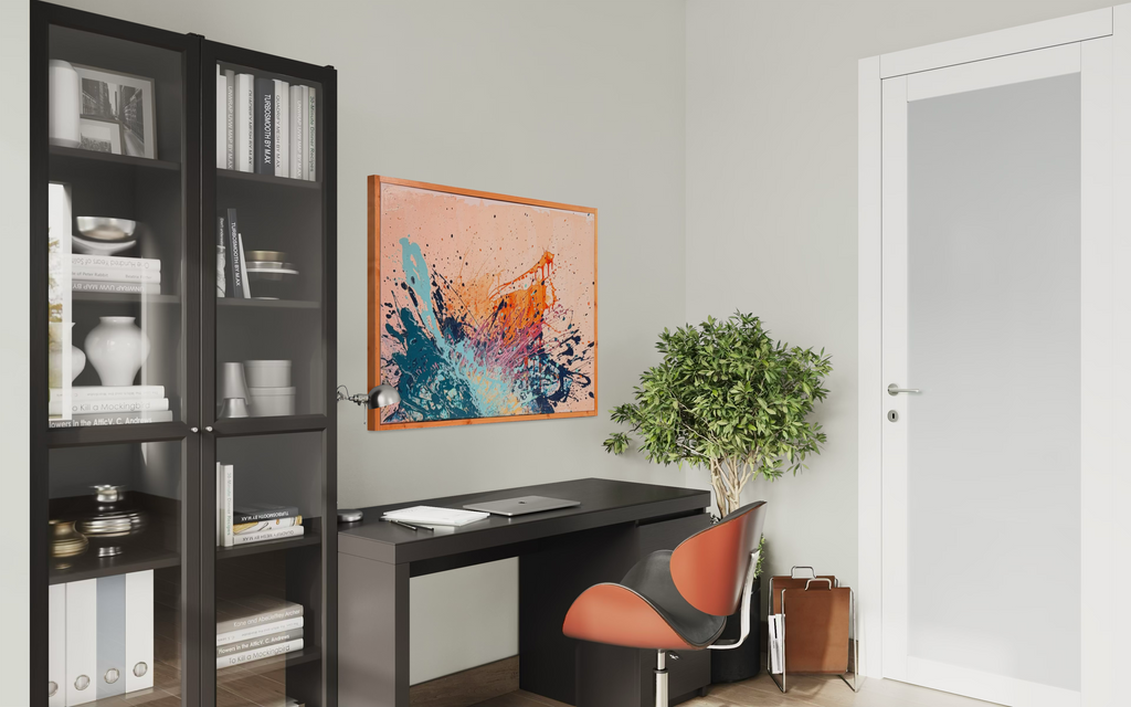 I Have My Own Gravity shown in a home office above a dark desk with an orange chair, beside black bookshelves and a potted tree.