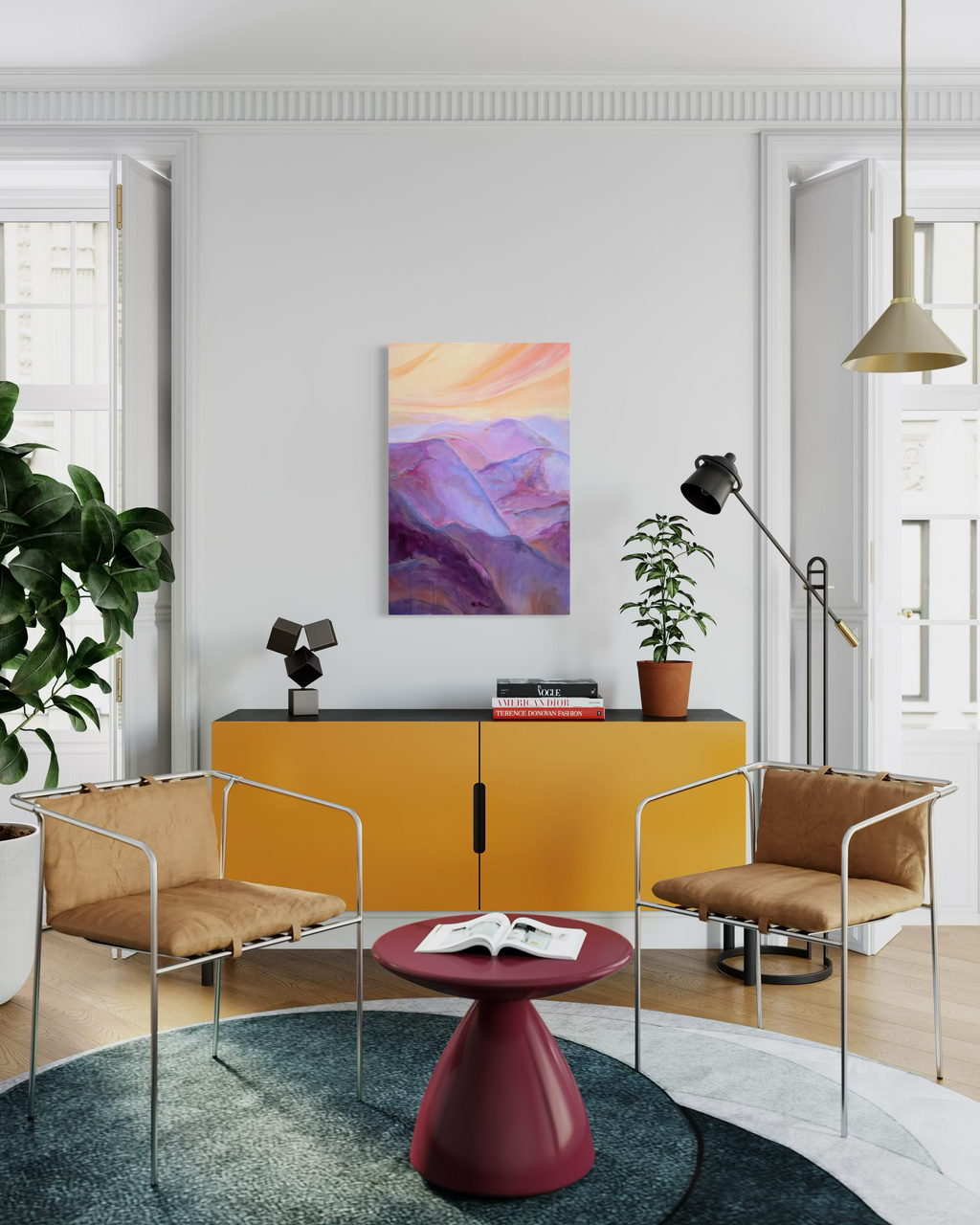 The View From My Latest Summit, in mixed media on stretched canvas: layered purple and magenta mountains under a peach sunset sky, shown above a mustard cabinet.