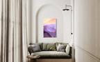 The View From My Latest Summit hanging in an arched alcove above an olive sofa, its purple mountain ranges glowing beneath a peach sky.