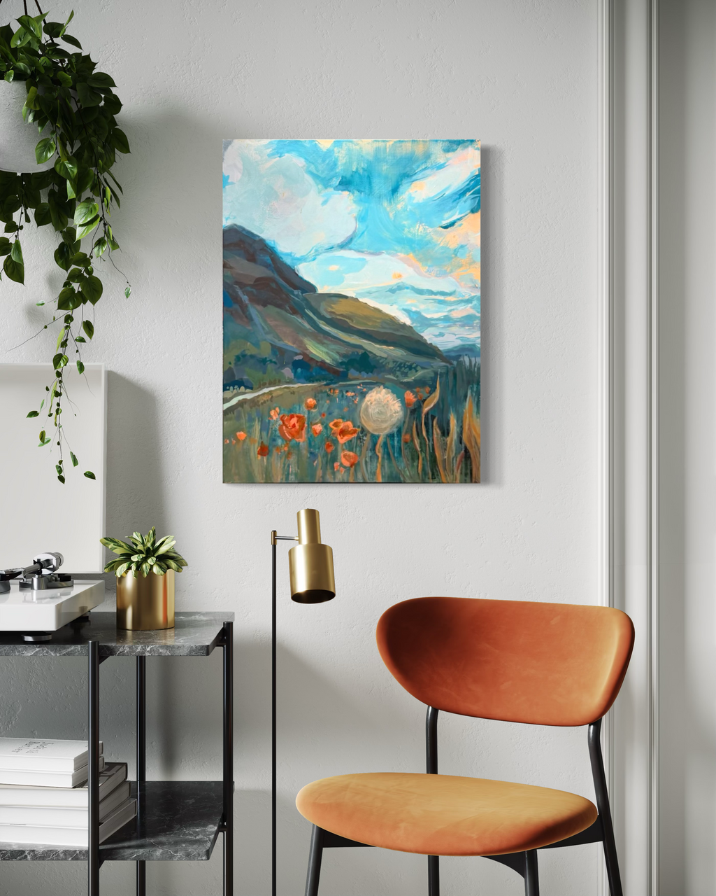 My Once Obliterated Self-Esteem, a landscape in mixed media on stretched canvas: a green hill, turquoise sky, orange poppies and a dandelion puff, shown above an orange chair.