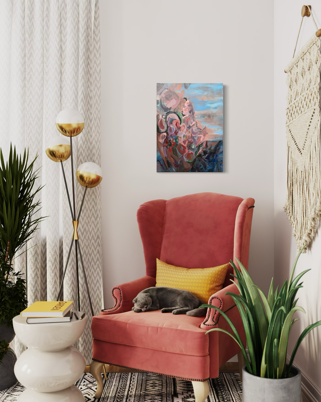 In Those Ashes, A Garden Grows hanging in a cozy reading corner above a coral wingback chair with a sleeping gray cat, gold floor lamp and macramé.