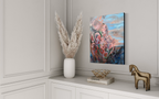 In Those Ashes, A Garden Grows shown on a paneled white wall above a white cabinet with pampas grass and a brass horse figurine.