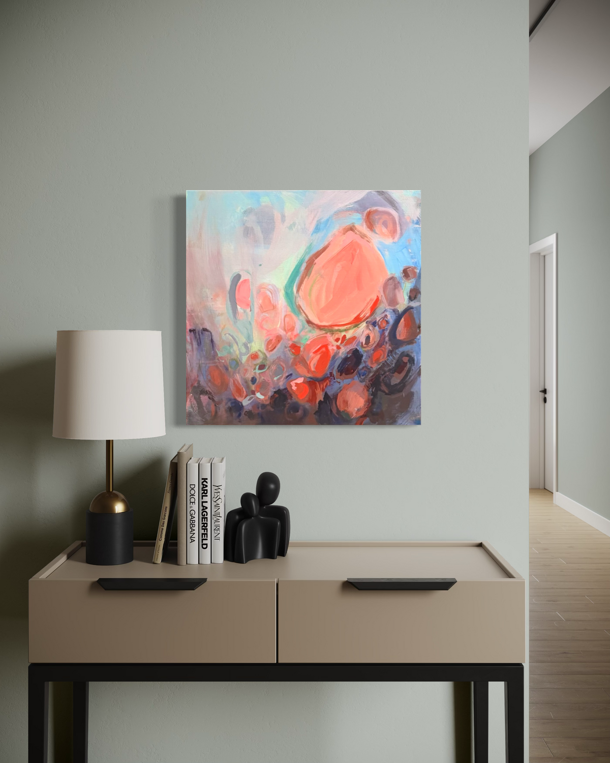 Soul Nourished, I Bloom Anew, a square abstract in mixed media on stretched canvas: a coral bloom rises from rose, navy and teal circles, shown above a beige console.