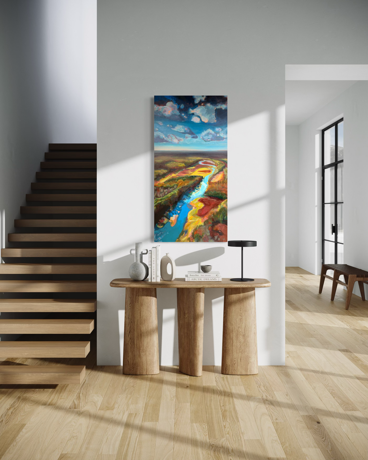 Where the Cahaba Winds, a tall painting in mixed media on gallery stretched canvas: a blue river winds through red, gold and green land under a cloudy sky, in an airy entryway.